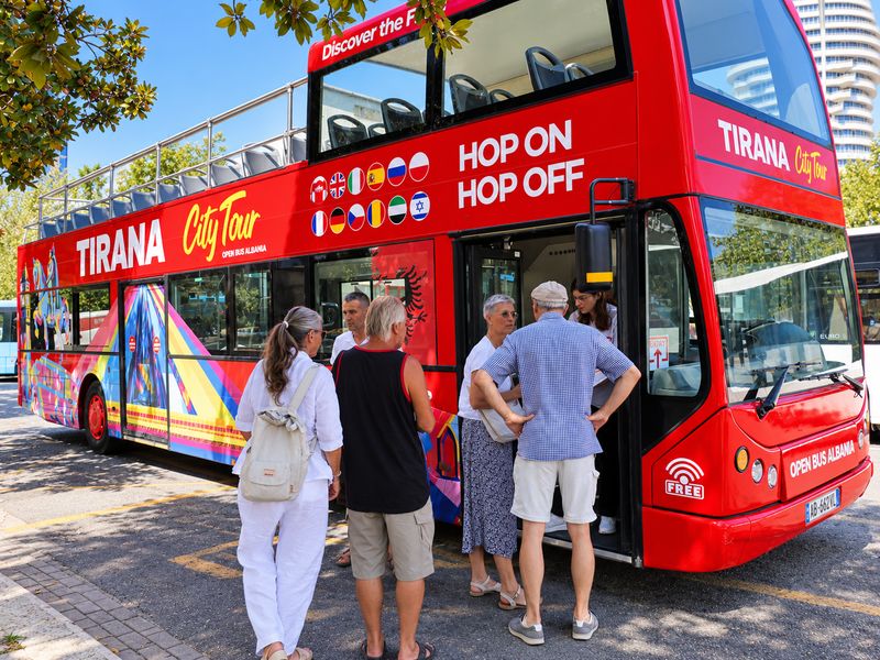 Visitors boarding the HOBUS Tirana City Tour bus at a stop